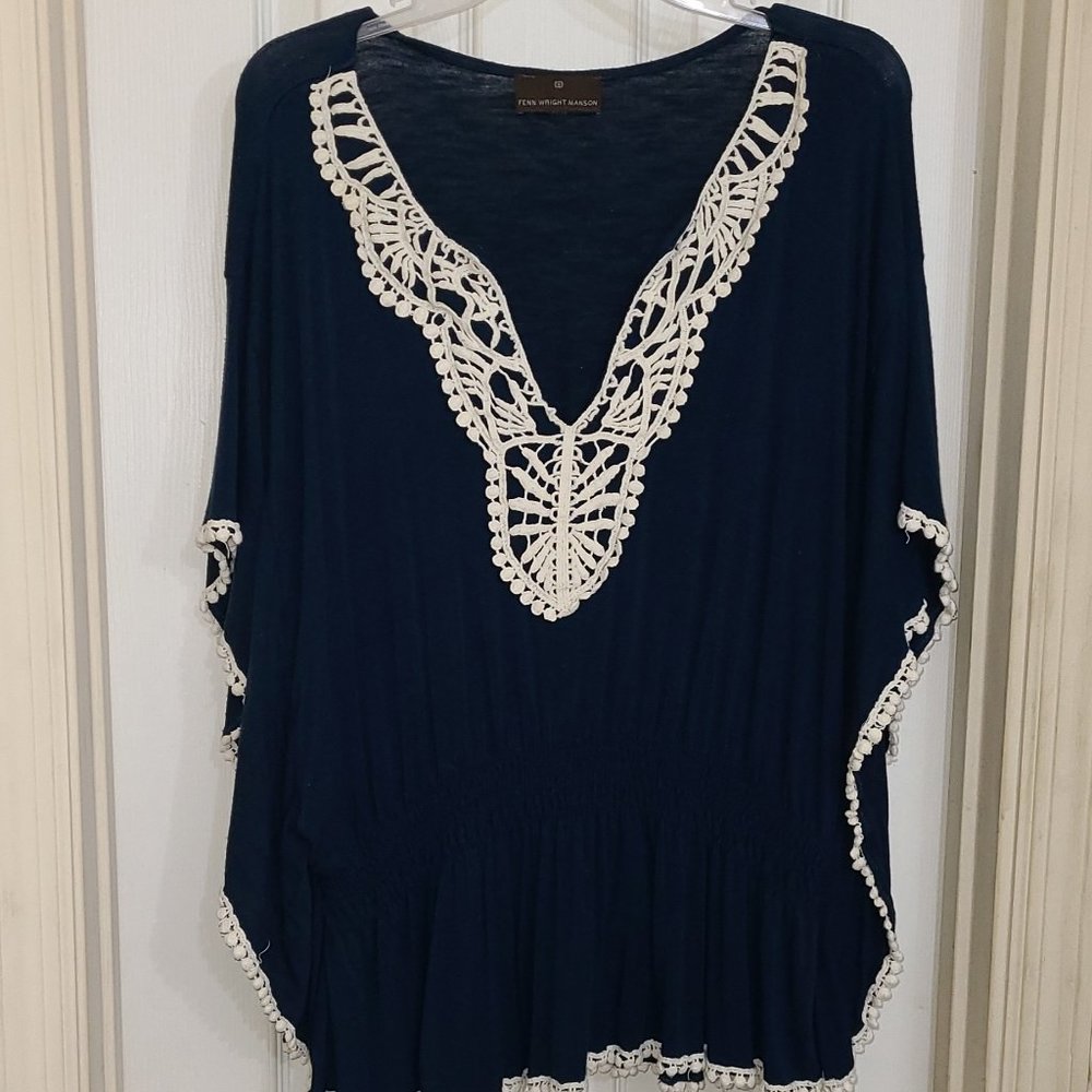 Navy blue blouse with white embroidery, elastic waist.